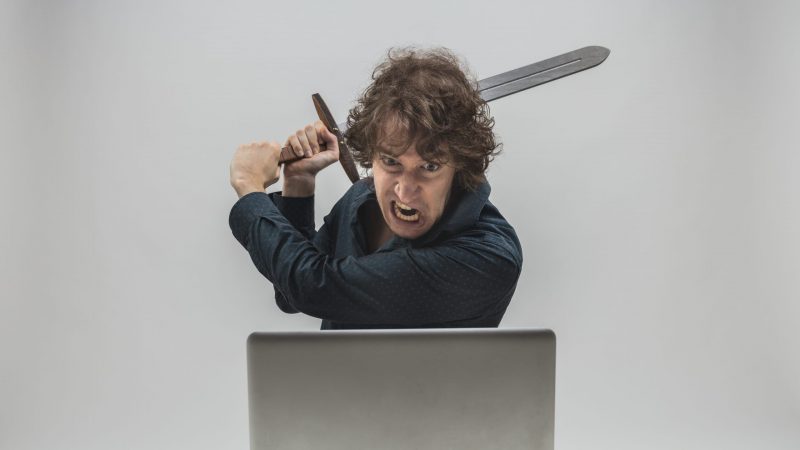 Angry Swordsman Destroying a Laptop